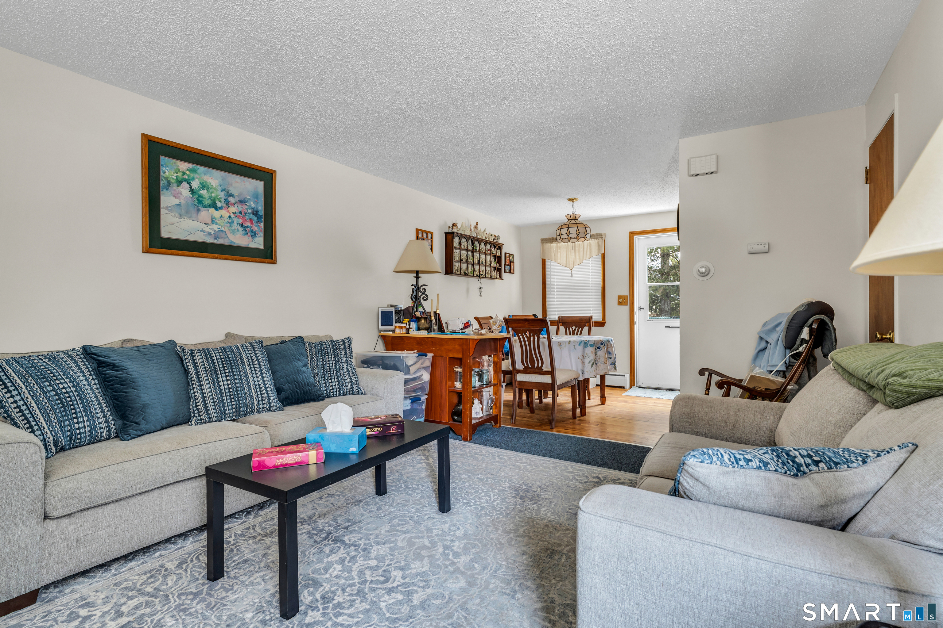 144 East Main Street, Unit 5 Clinton, CT 06413 - Photo 7 of 19 a living room with furniture and a table