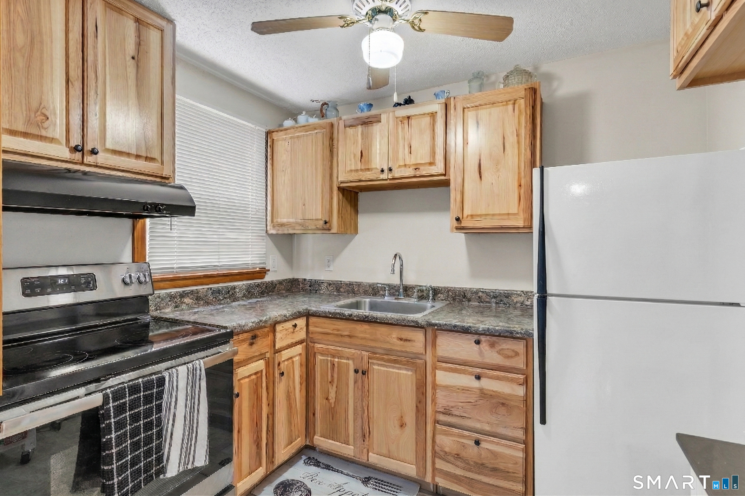 144 East Main Street, Unit 5 Clinton, CT 06413 - Photo 8 of 26 a kitchen with stainless steel appliances granite countertop a sink stove and refrigerator