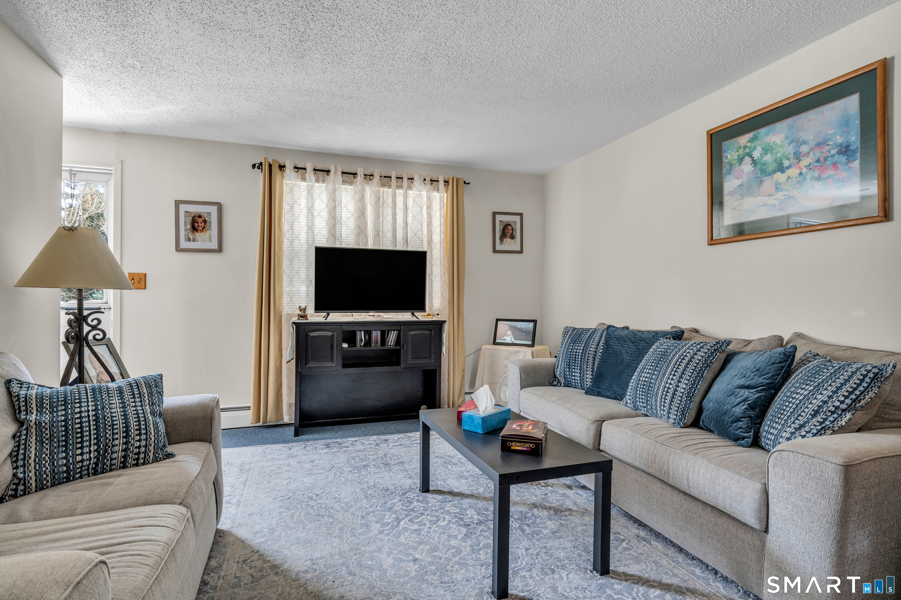 144 East Main Street, Unit 5 Clinton, CT 06413 - Photo 9 of 19 a living room with furniture and a flat screen tv