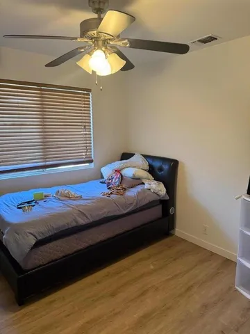 a bedroom with a bed and a window