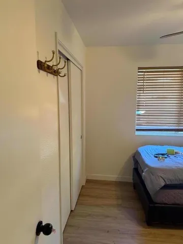 a view of a room with wooden floor and ceiling fan
