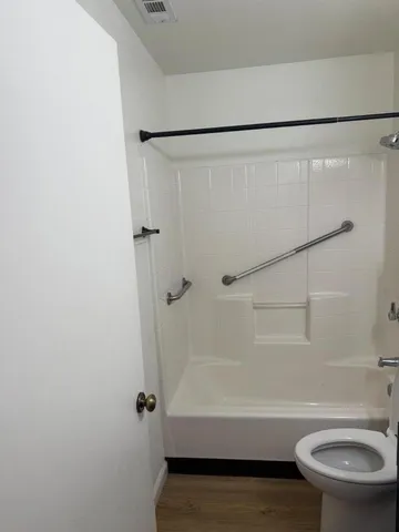 a bathroom with a sink toilet and a mirror