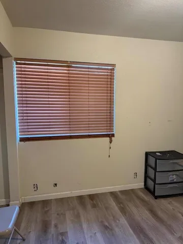 a bed room with a bed and teddy bear on bed