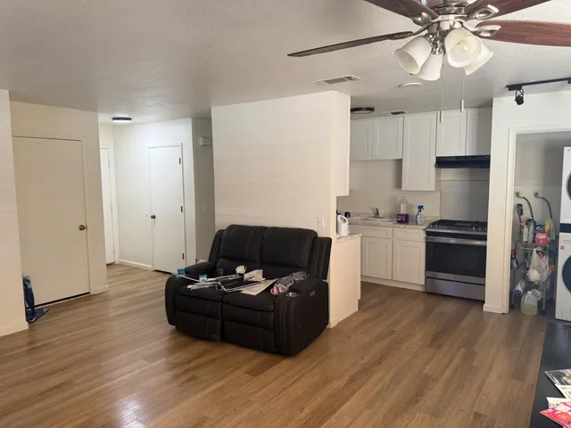 a living room with furniture and kitchen view