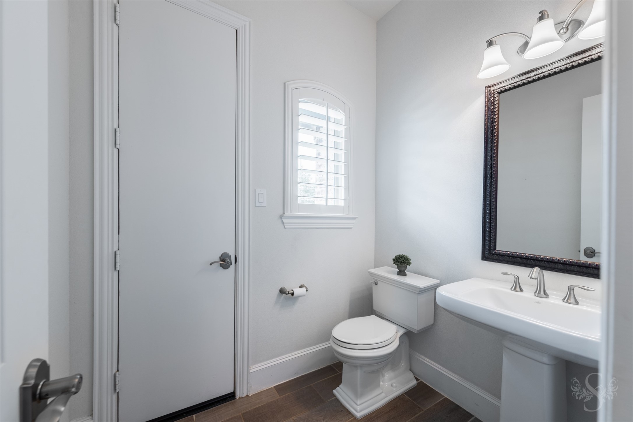 28602 Hoffman Spring Lane Fulshear, TX 77441 - Photo 19 of 49 Stylish pool bath is thoughtfully positioned near the breakfast area and outdoor living spaces for added convenience. Featuring elegant pedestal sink styling, framed mirror and window with plantation shutters