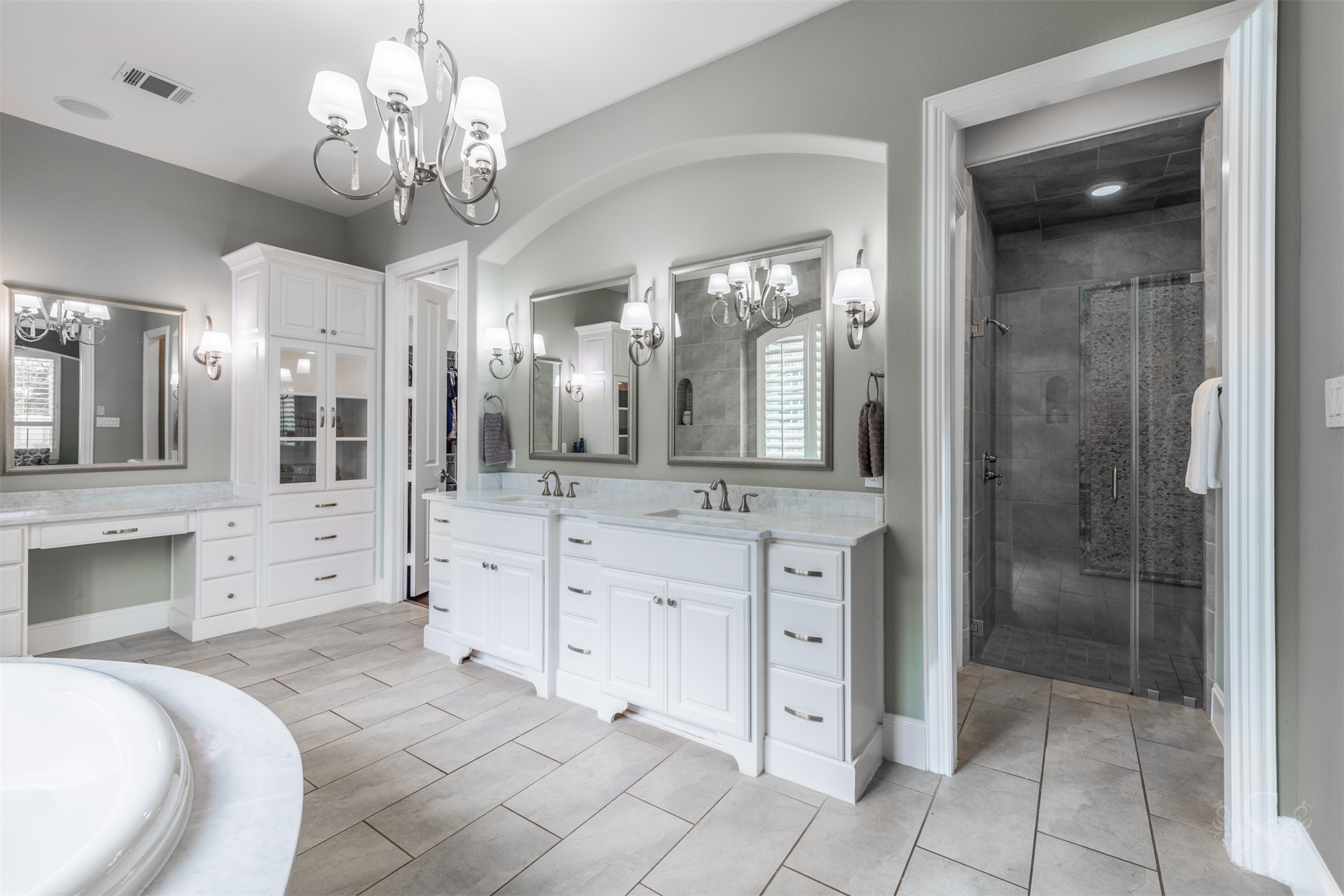 28602 Hoffman Spring Lane Fulshear, TX 77441 - Photo 22 of 49 Dual vanities with extensive counter space are complemented by custom cabinetry, framed mirrors, and elegant lighting. Oversized walk-in shower with detailed tilework and glass enclosure completes this well-appointed bath.