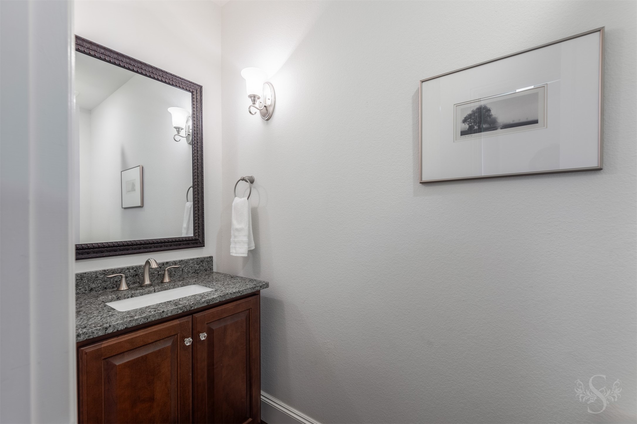 28602 Hoffman Spring Lane Fulshear, TX 77441 - Photo 24 of 49 Well-appointed secondary bath features granite countertops and framed mirror. Conveniently connected to the downstairs secondary bedroom, this private bath offers comfort and functionality for guests or multigenerational living.
