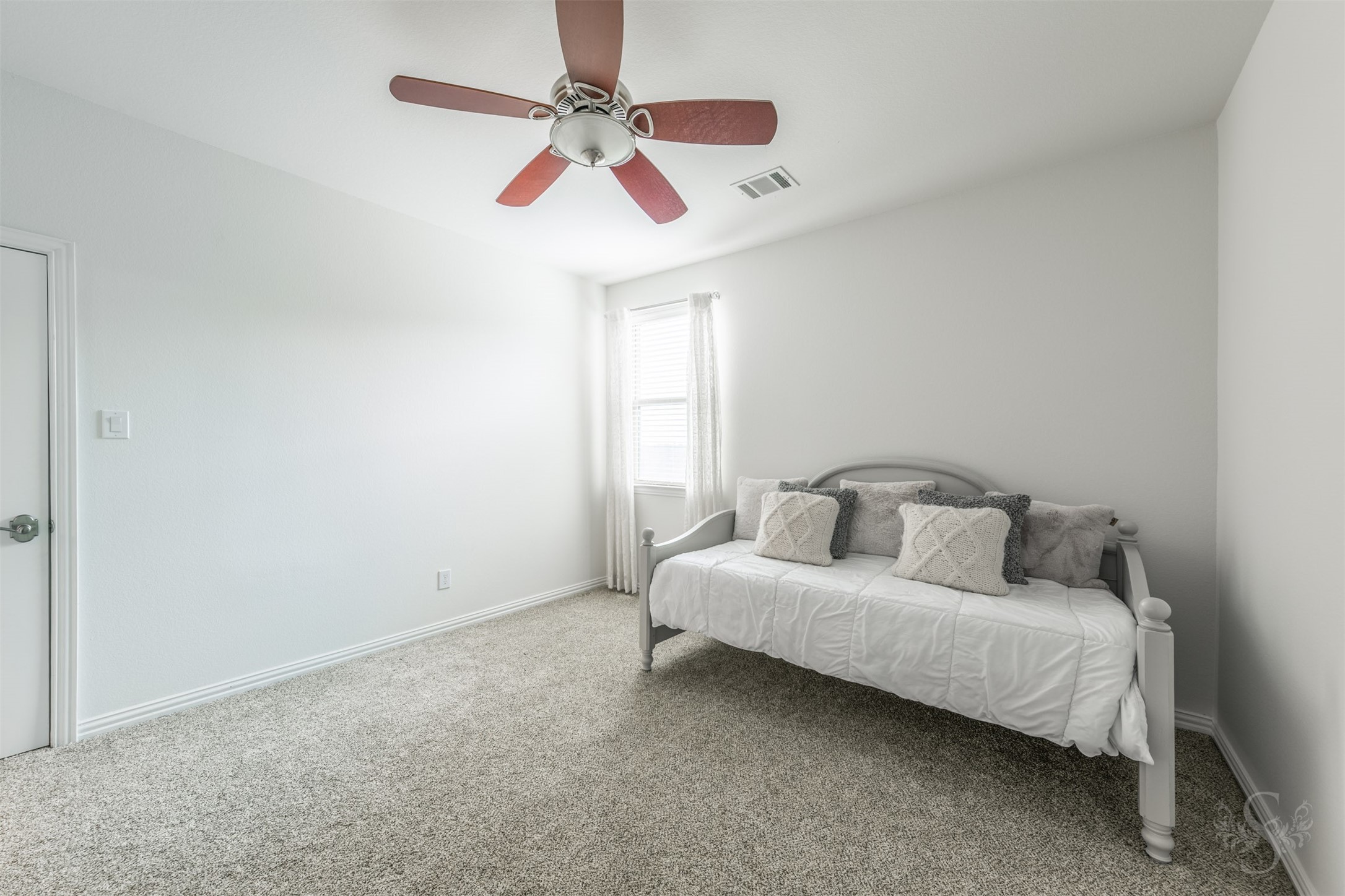 28602 Hoffman Spring Lane Fulshear, TX 77441 - Photo 34 of 49 Well-proportioned secondary bedroom features plush carpeting, a ceiling fan, and plantation shutters for a clean, comfortable setting. The layout easily accommodates full bedroom furnishings along with a desk or study area, and includes access to a private full bath.