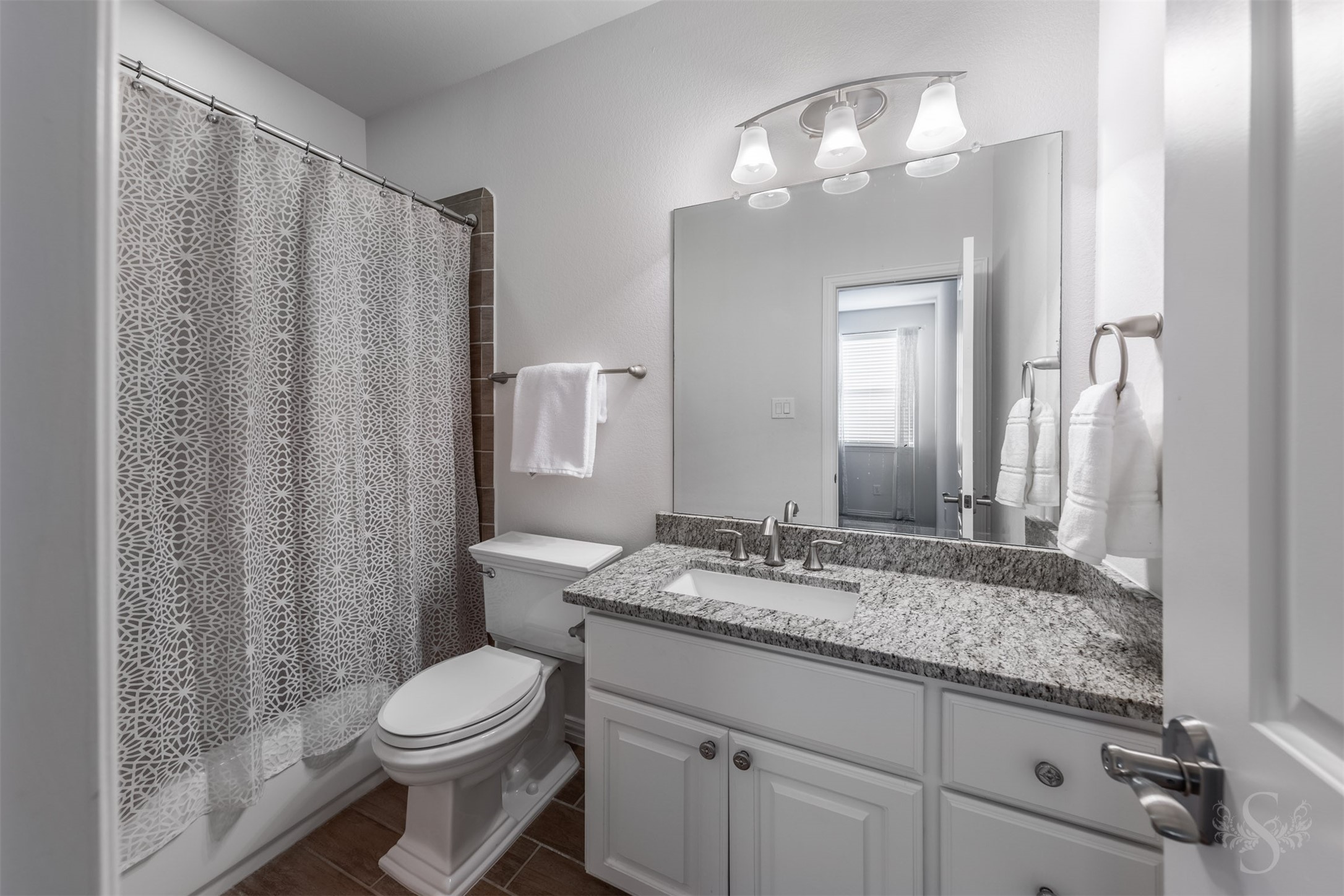 28602 Hoffman Spring Lane Fulshear, TX 77441 - Photo 35 of 49 Each bedroom is complemented by its own full bath featuring a shower/tub combination, granite countertops, framed mirrors, and polished fixtures. Clean, well-maintained finishes provide a fresh, elevated feel while offering added convenience for daily routines.