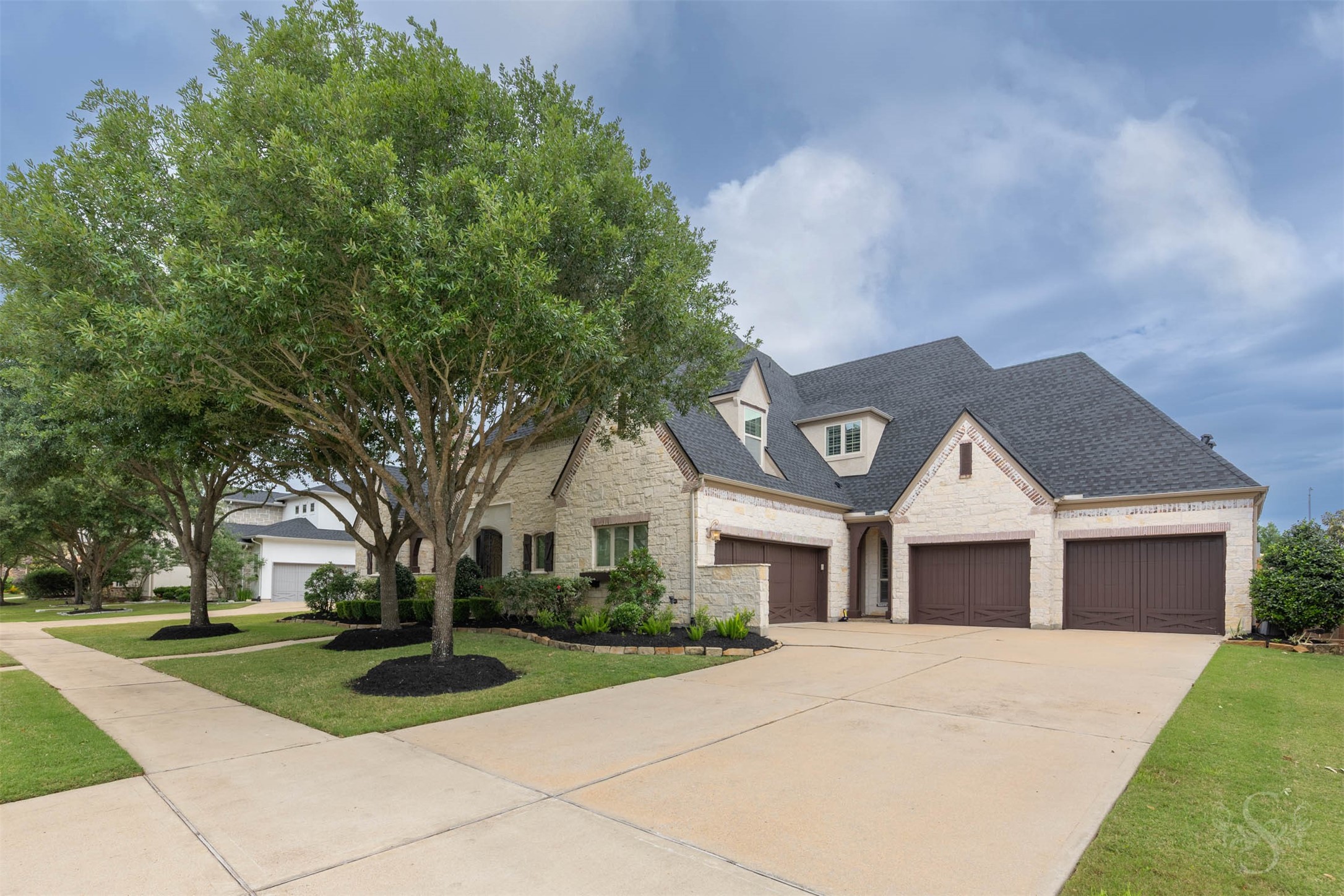 28602 Hoffman Spring Lane Fulshear, TX 77441 - Photo 46 of 49 Striking 2 story Huntington home features a rare 4 car garage, expansive driveway and a beautifully designed exterior with classic stone and brick accents. Positioned on a premium greenbelt lot in the gated section of Legacy at Cross Creek Ranch, this home offers an impressive blend of luxury and functionality.
