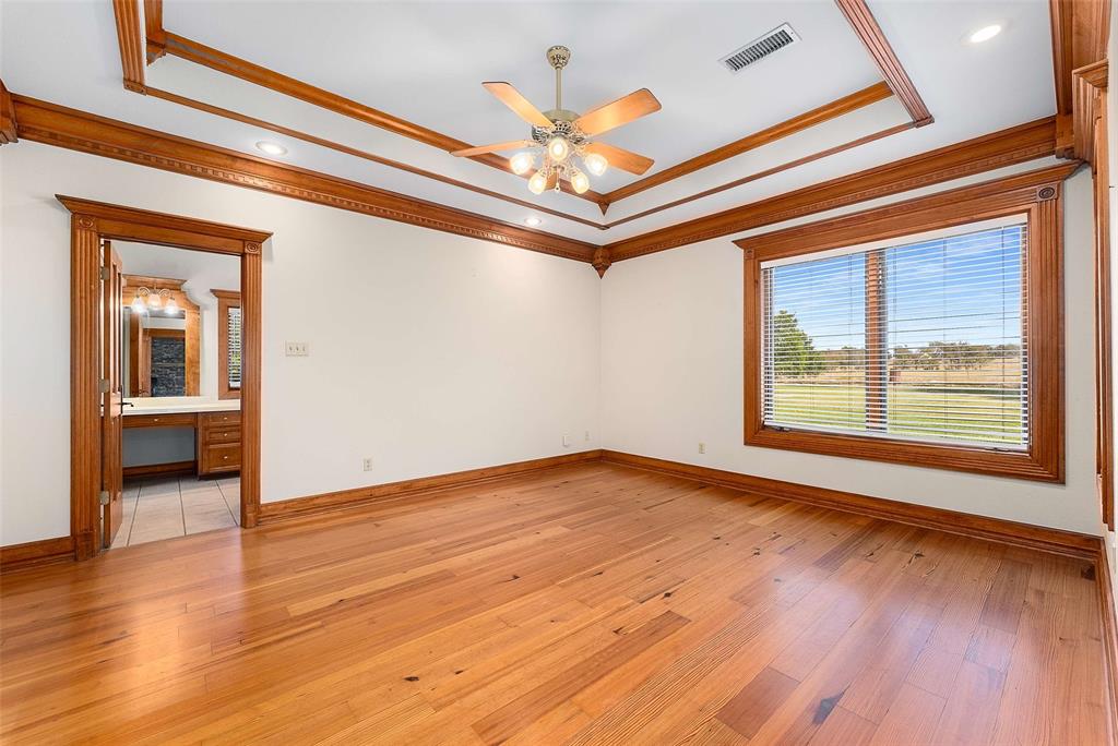 11631 Hiram Road Wills Point, TX 75169 - Photo 13 of 29 a view of an empty room with wooden floor and a window