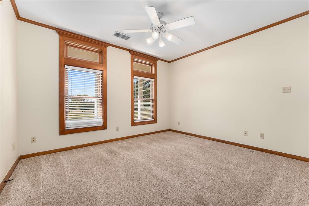 11631 Hiram Road Wills Point, TX 75169 - Photo 17 of 29 an empty room with windows and fan