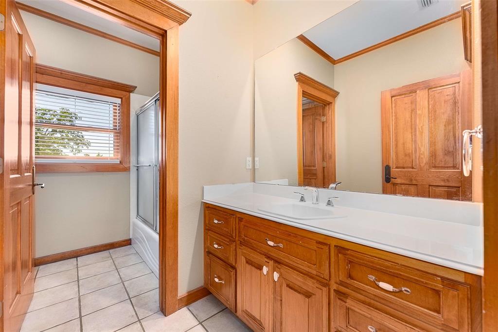 11631 Hiram Road Wills Point, TX 75169 - Photo 19 of 29 a spacious bathroom with a granite countertop sink and a mirror