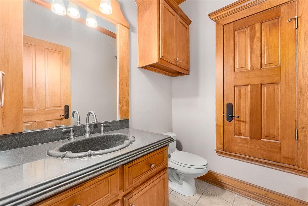 11631 Hiram Road Wills Point, TX 75169 - Photo 22 of 29 a bathroom with a granite countertop sink toilet and shower