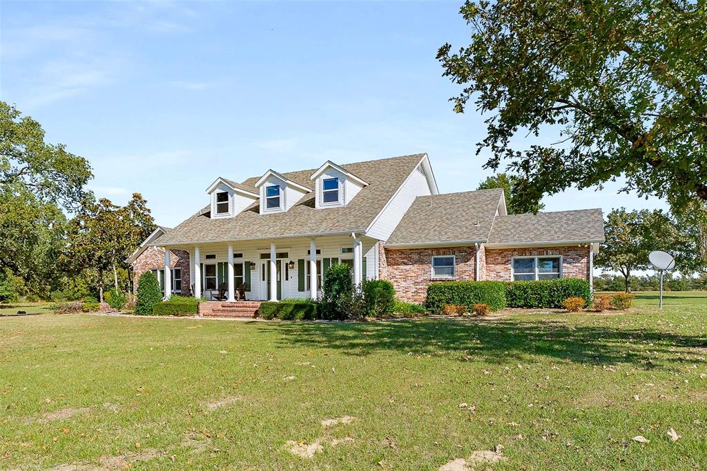 11631 Hiram Road Wills Point, TX 75169 - Photo 4 of 29 a front view of a house with a garden