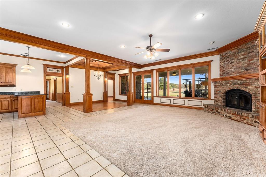 11631 Hiram Road Wills Point, TX 75169 - Photo 5 of 29 a view of an empty room with a fireplace and chandelier