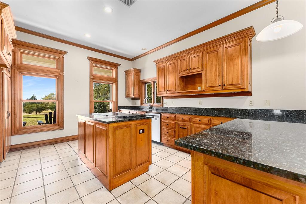11631 Hiram Road Wills Point, TX 75169 - Photo 9 of 29 a kitchen with stainless steel appliances granite countertop a stove a sink and a microwave