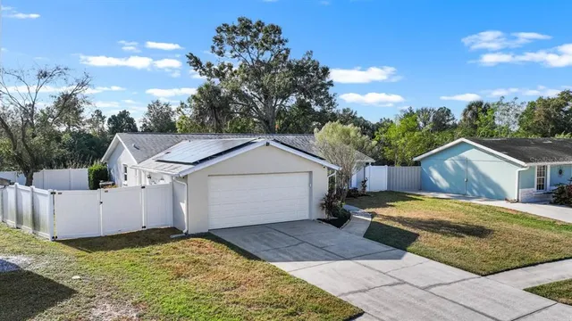a view of a white house with a yard and garage