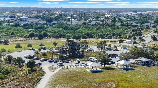 an aerial view of residential houses with outdoor space and parking