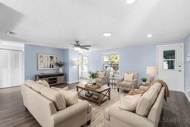 a living room with furniture a fireplace and a window