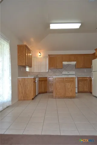 a large kitchen with a cabinets and window