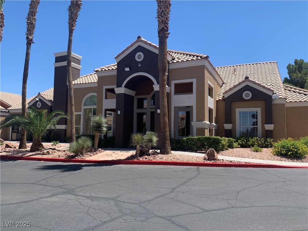 8101 West Flamingo Road, Unit 1102 Las Vegas, NV 89147 - Photo 2 of 54 View of front of home featuring stucco siding and a tiled roof