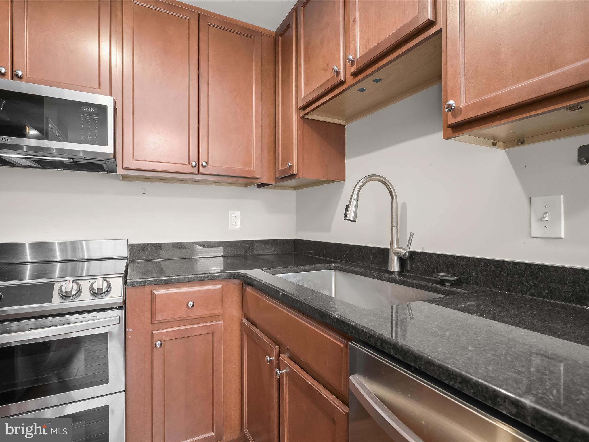 17617 Kohlhoss Road Poolesville, MD 20837 - Photo 13 of 48 a kitchen with granite countertop a sink stainless steel appliances and cabinets