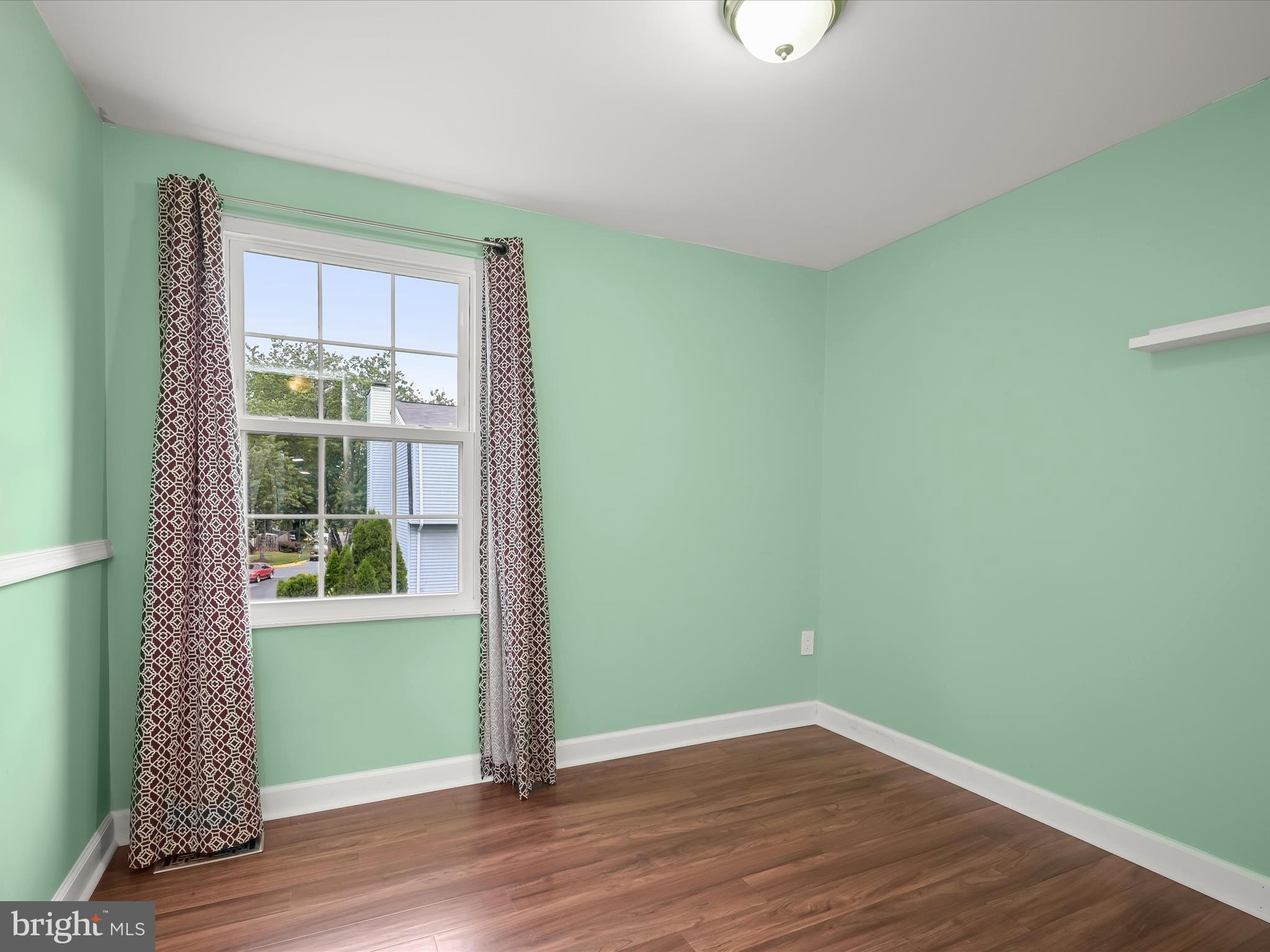 17617 Kohlhoss Road Poolesville, MD 20837 - Photo 27 of 48 a view of an empty room with wooden floor and a window