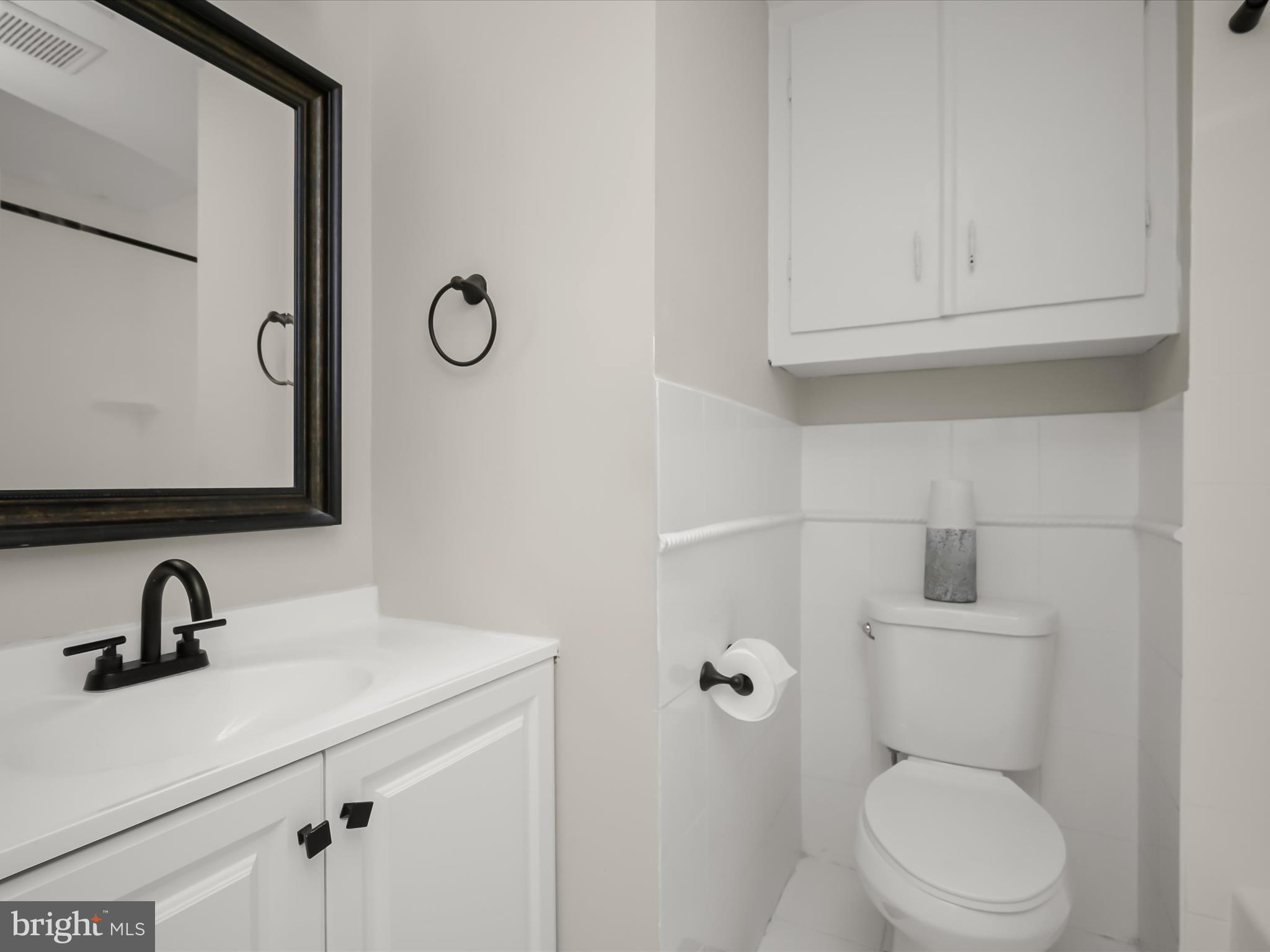17617 Kohlhoss Road Poolesville, MD 20837 - Photo 33 of 48 a bathroom with a sink a toilet and a mirror