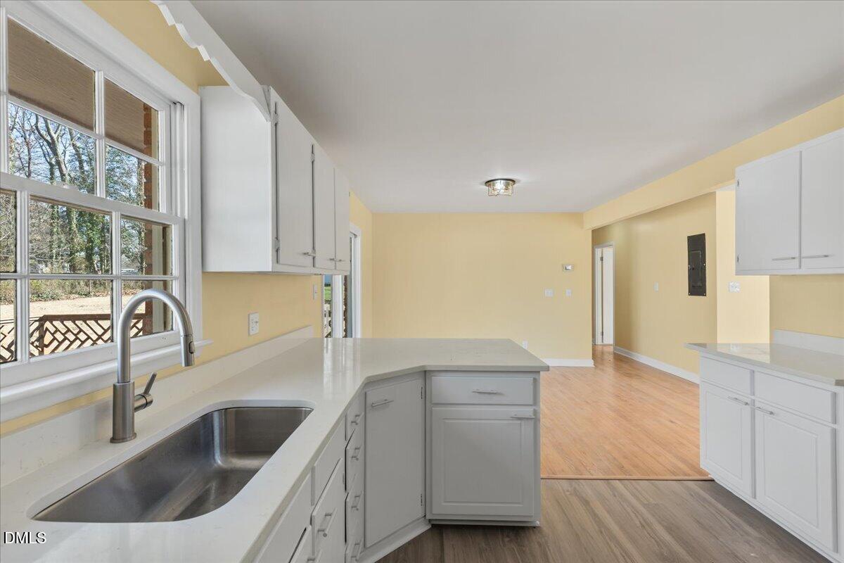 3620 Oates Drive Raleigh, NC 27604 - Photo 11 of 26 a kitchen with a sink and a refrigerator