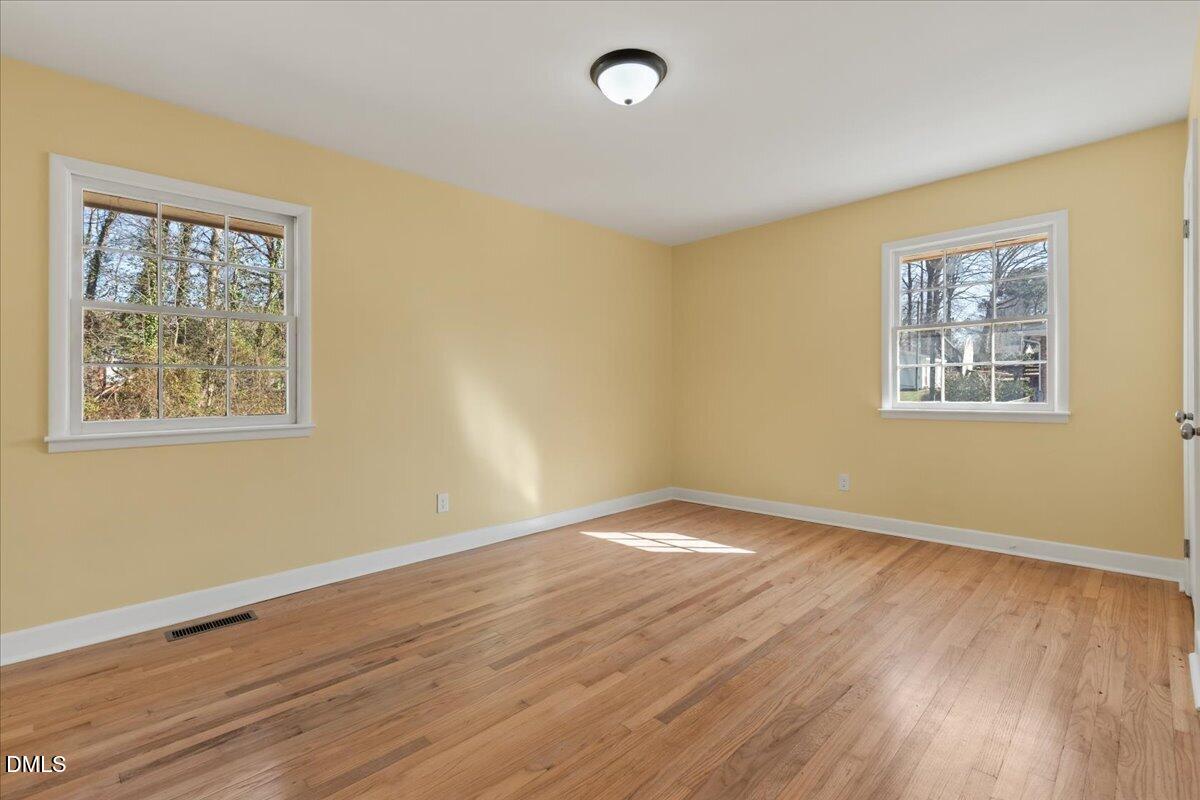 3620 Oates Drive Raleigh, NC 27604 - Photo 14 of 26 a view of empty room with wooden floor and fan