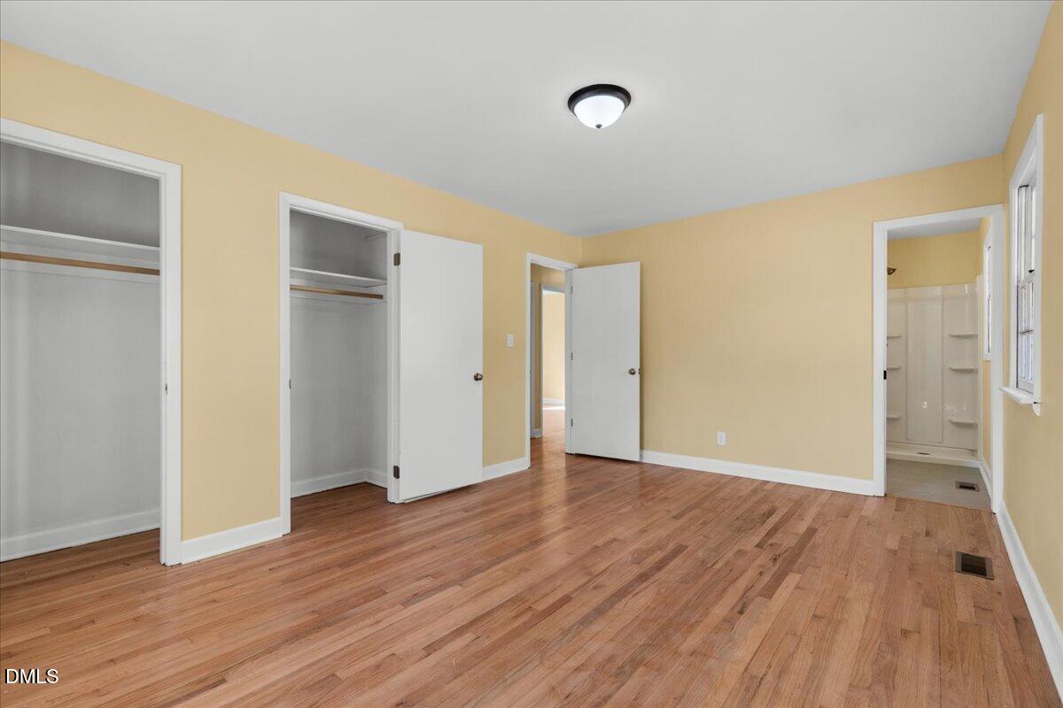 3620 Oates Drive Raleigh, NC 27604 - Photo 15 of 26 a view of an empty room with wooden floor and a window