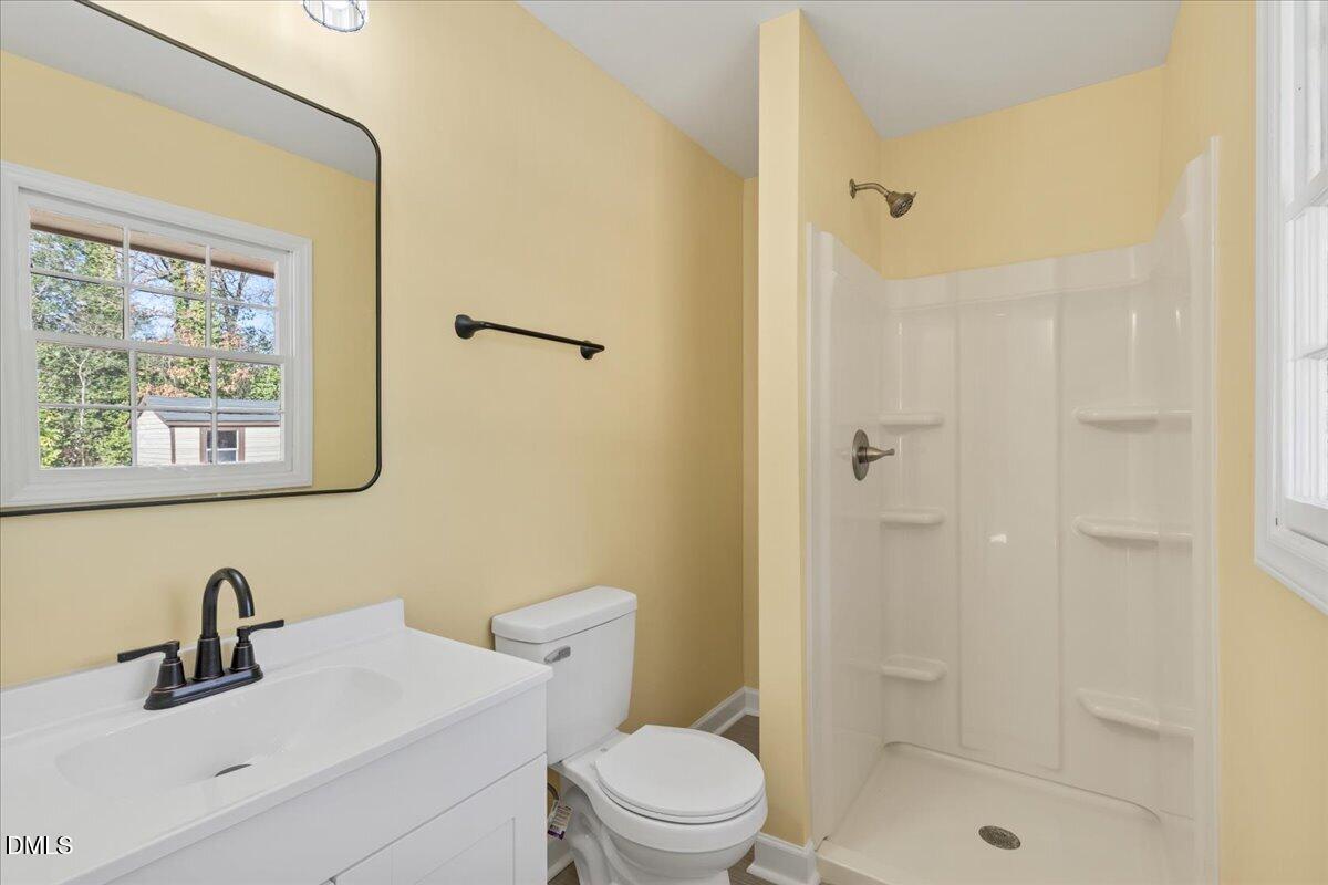 3620 Oates Drive Raleigh, NC 27604 - Photo 16 of 26 a bathroom with a sink toilet a mirror and shower