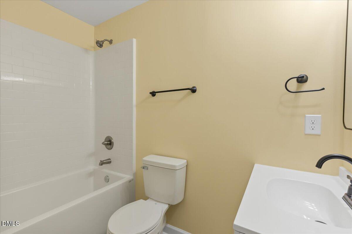 3620 Oates Drive Raleigh, NC 27604 - Photo 18 of 26 a white toilet sitting next to a bath tub