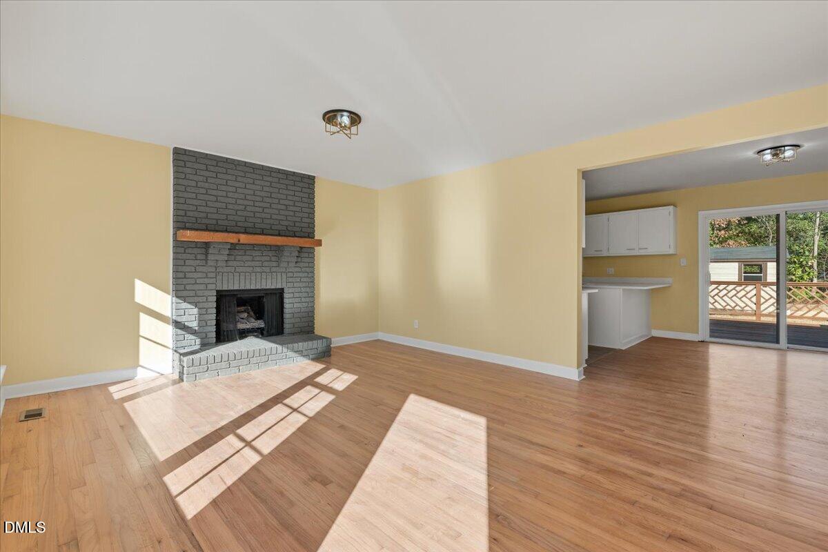 3620 Oates Drive Raleigh, NC 27604 - Photo 3 of 26 a view of a livingroom with wooden floor and a fireplace