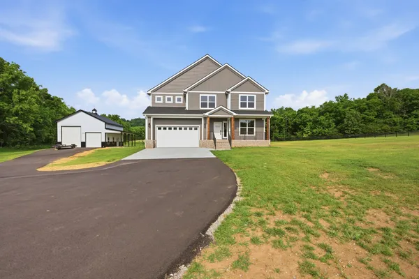a front view of a house with a yard and garage