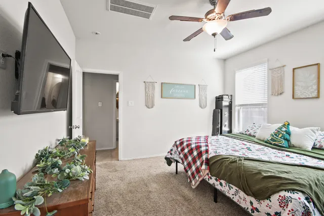 a bedroom with a bed and a chandelier