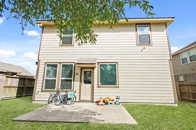 a front view of a house with a garden and plants