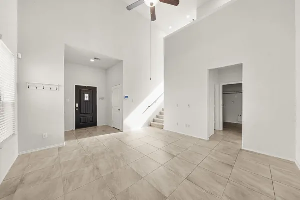 a view of an empty room with a ceiling fan