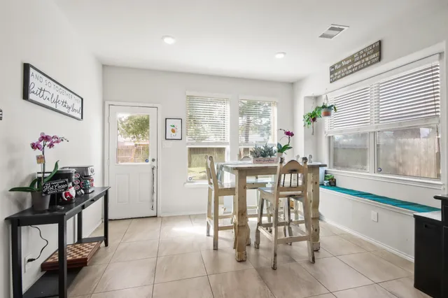 a dining room with furniture and window