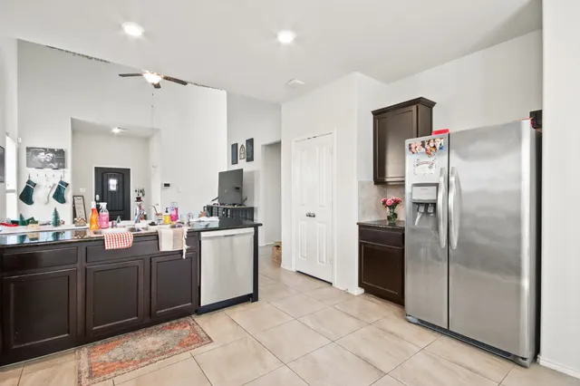 a kitchen with a refrigerator and a sink