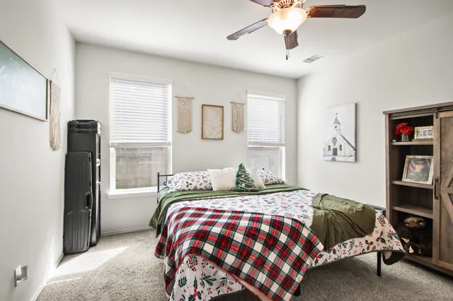 a bedroom with a bed and a chandelier