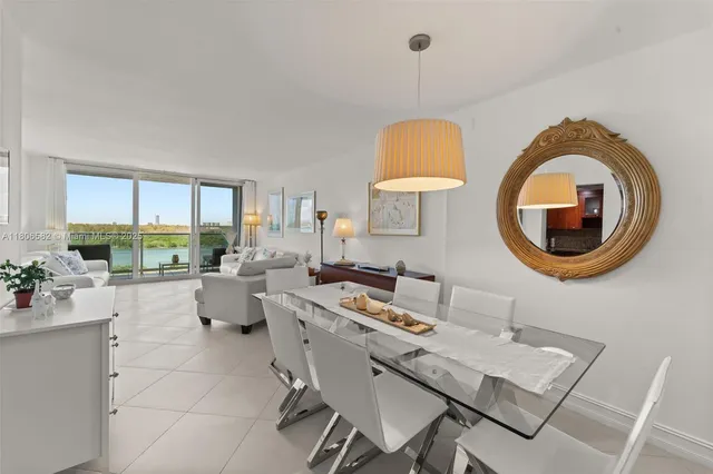 a living room with furniture a table and a large window