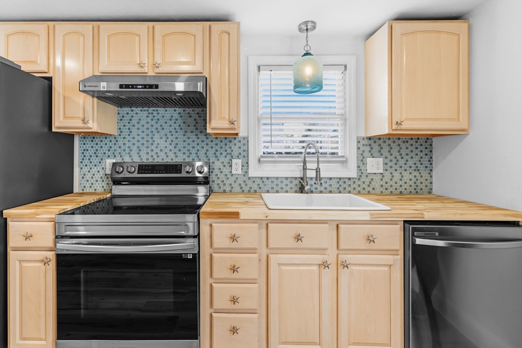 8 Cottage Street Wareham, MA 02571 - Photo 6 of 30 a kitchen with stainless steel appliances granite countertop a stove a sink and a microwave