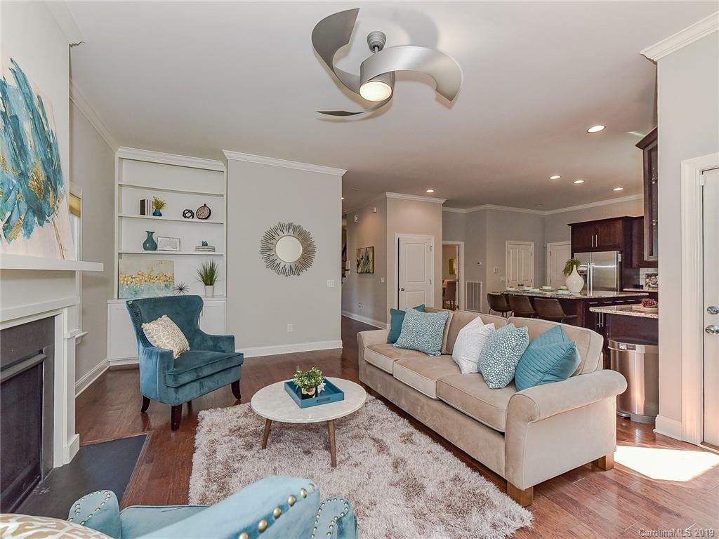 723 Harvest Pointe Drive Fort Mill, SC 29708 - Photo 15 of 47 a living room with furniture kitchen view and a fireplace
