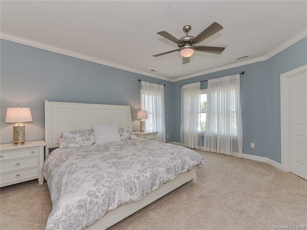 723 Harvest Pointe Drive Fort Mill, SC 29708 - Photo 23 of 47 a bedroom with a large bed and a ceiling fan