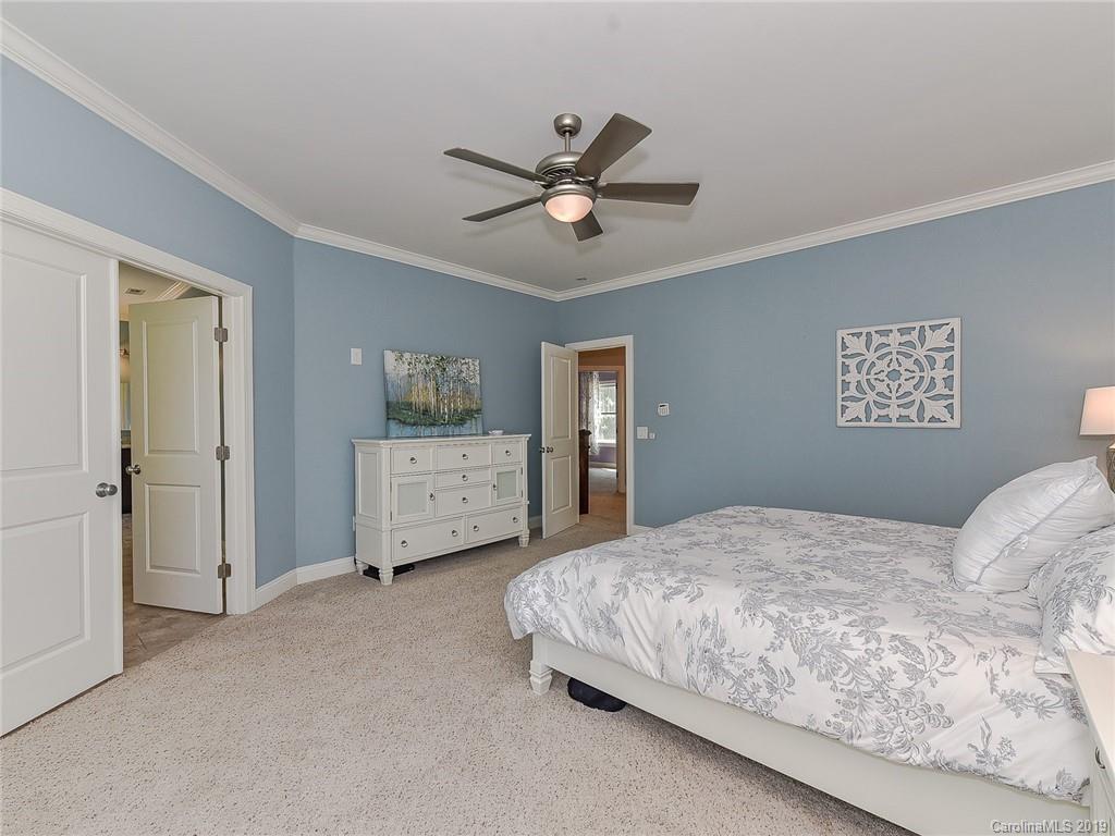 723 Harvest Pointe Drive Fort Mill, SC 29708 - Photo 24 of 47 a bedroom with a bed and a chandelier