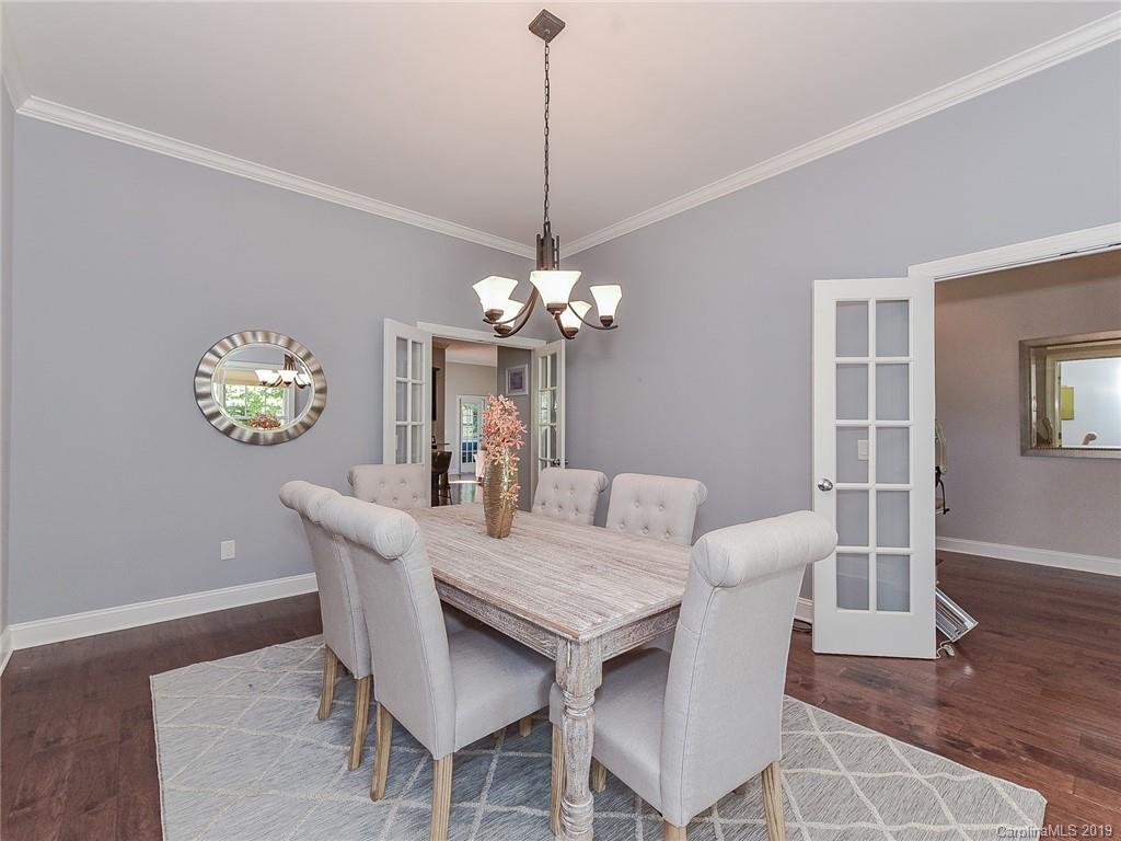 723 Harvest Pointe Drive Fort Mill, SC 29708 - Photo 9 of 47 a dining room with furniture a chandelier and wooden floor