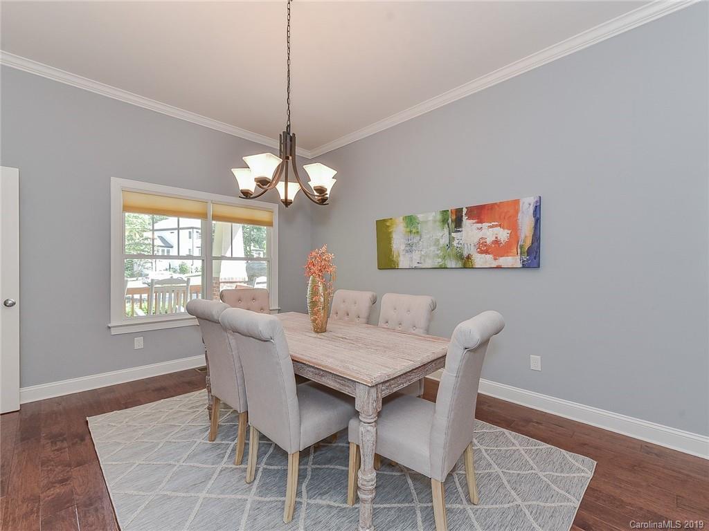 723 Harvest Pointe Drive Fort Mill, SC 29708 - Photo 10 of 47 a view of a dining room with furniture a chandelier and wooden floor