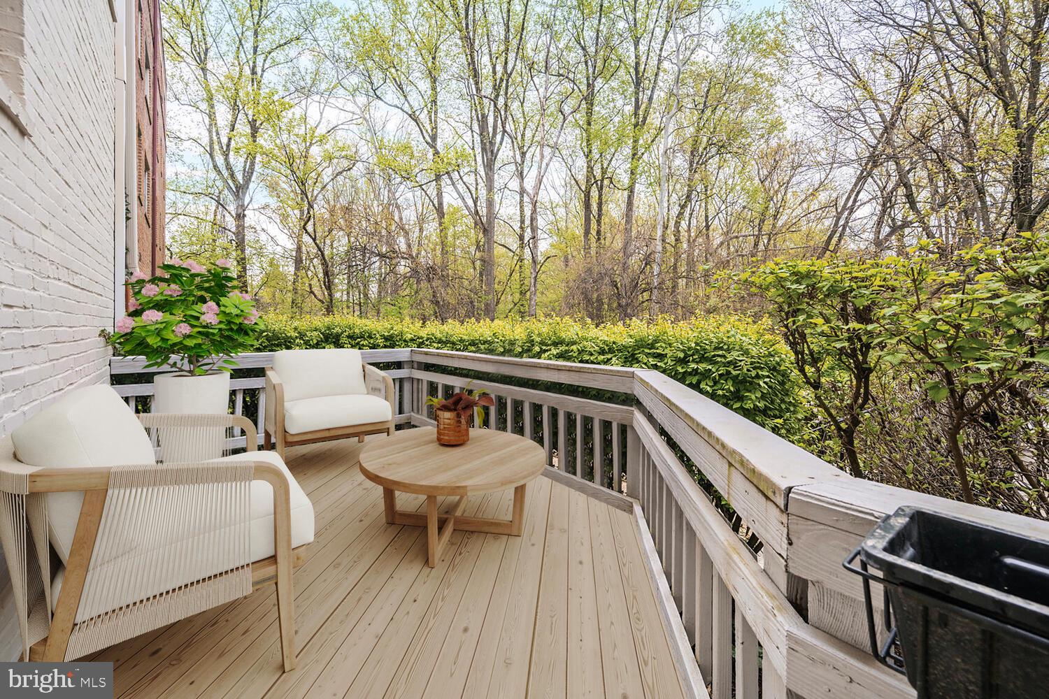 2212 Washington Avenue, Unit 102 Silver Spring, MD 20910 - Photo 1 of 27 a balcony with wooden floor and outdoor seating